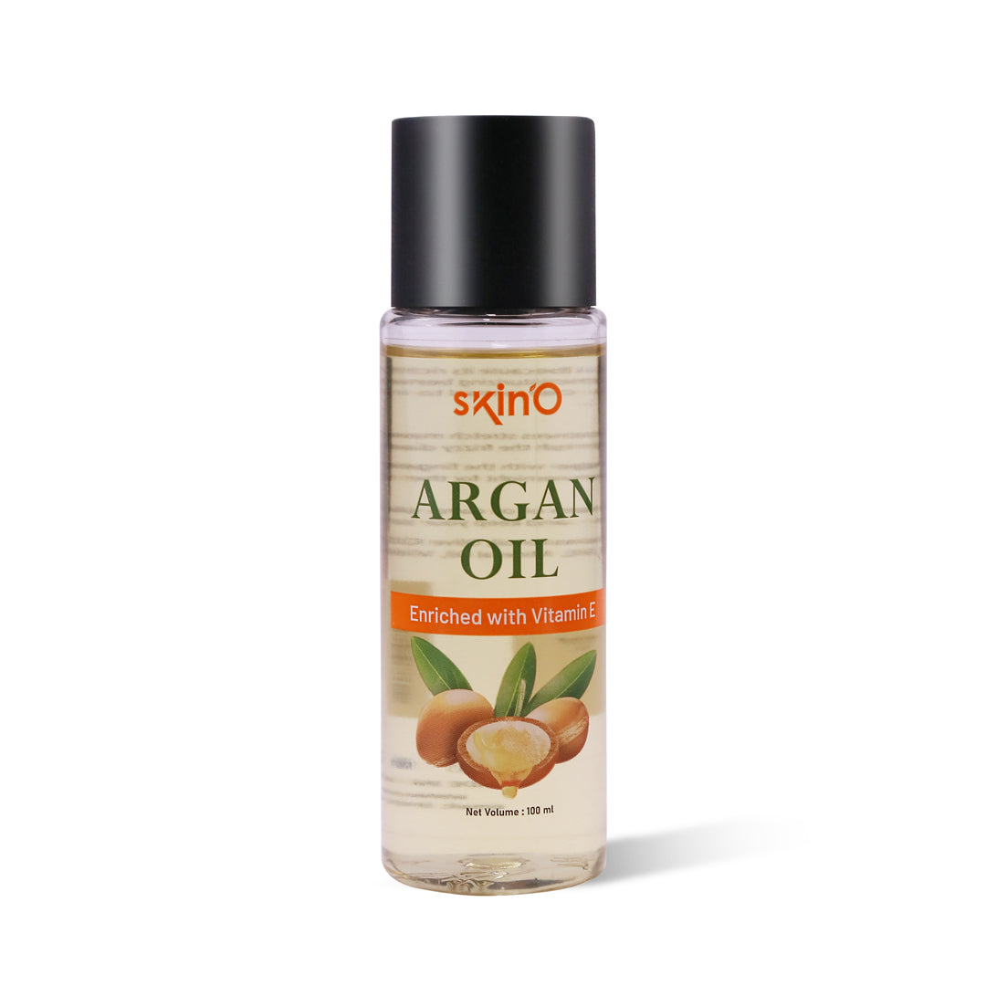 Close-up of golden SkinO Argan Oil on a surface.

